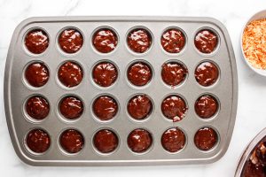 muffin tins filled with brownie batter