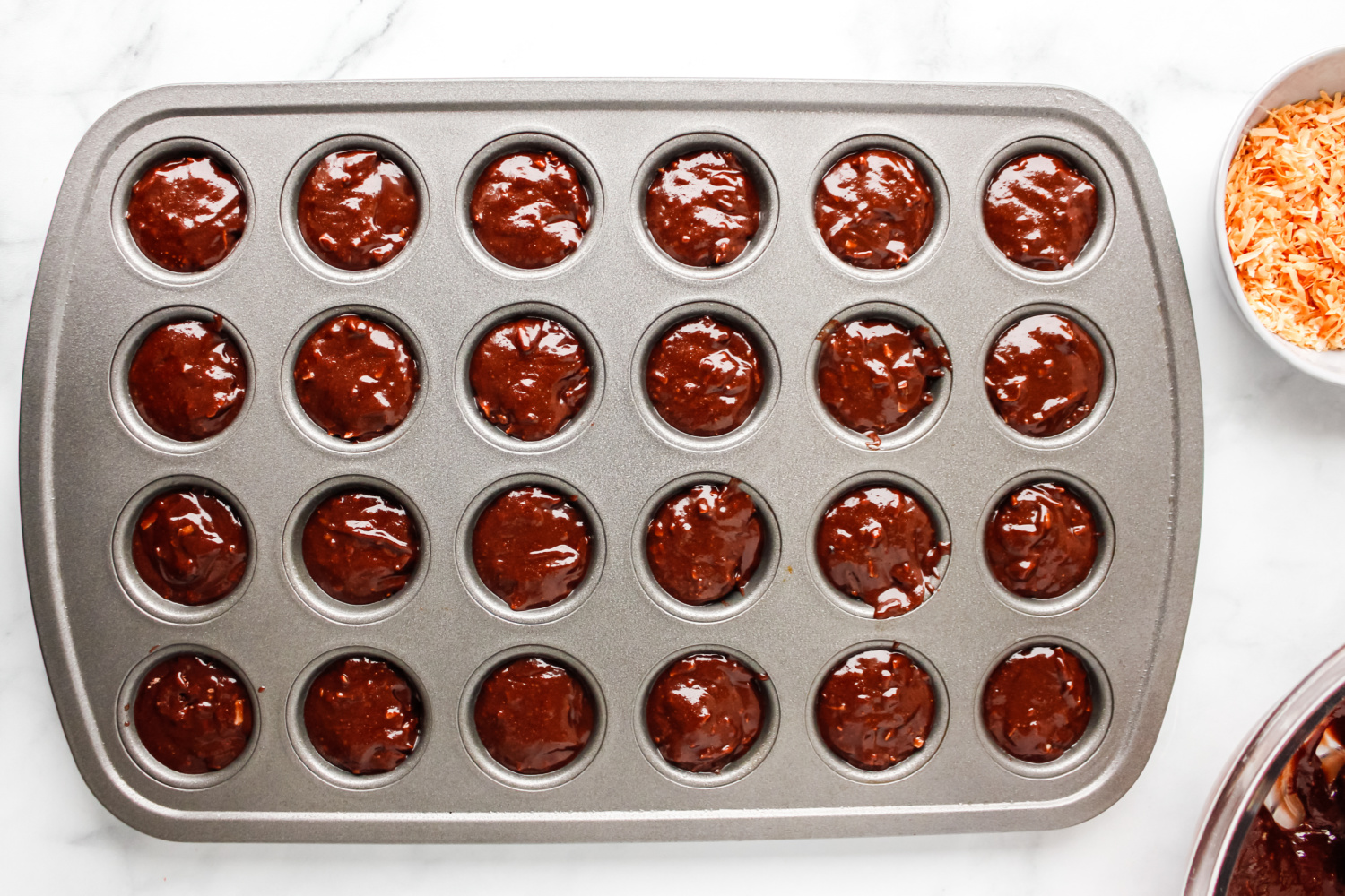 muffin tins filled with brownie batter